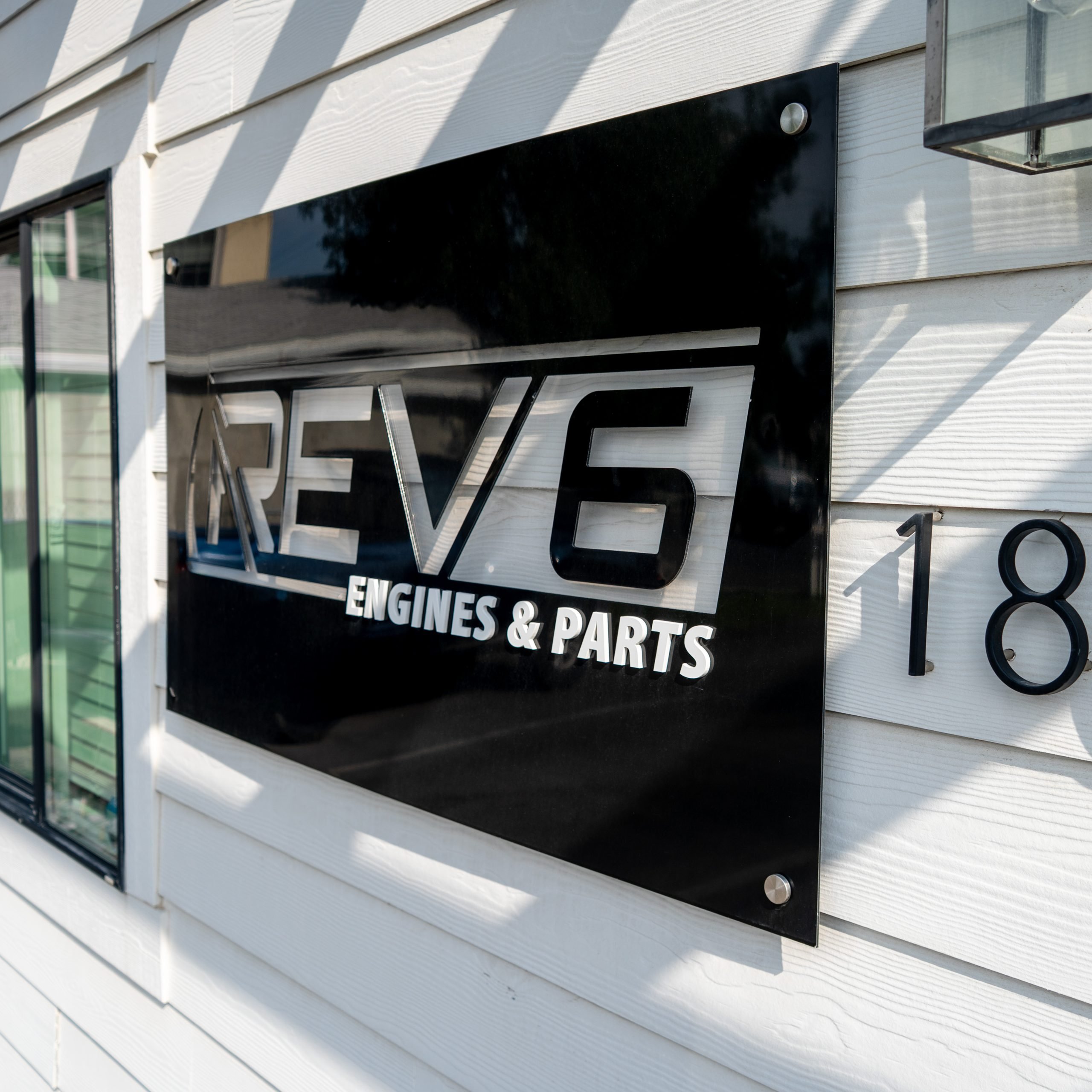 REV6 Engines & Parts building sign mounted on exterior wall at company headquarters.