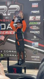 REV6 sponsored rider, Zeppelin on the podium holding up his award.