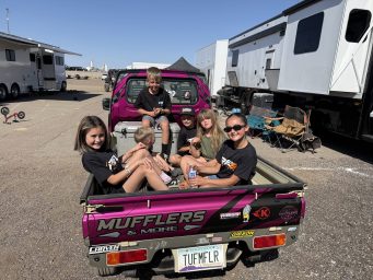 Kids in the back of a truck all wearing Rev6 t-shirts